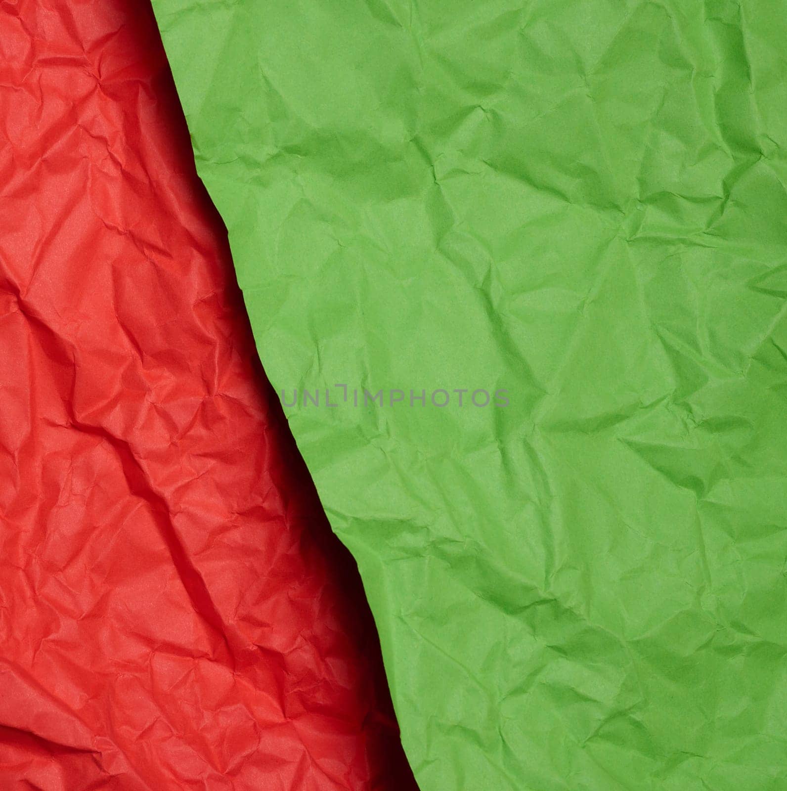 Crumpled red and green paper sheets, paper texture. Background for designers