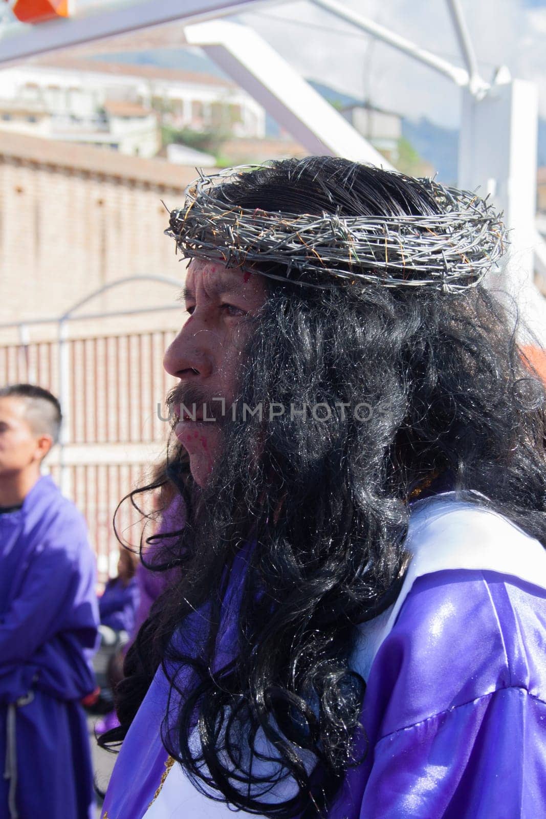 long-haired nazareno with a crown of thorns in a holy week procession. High quality photo