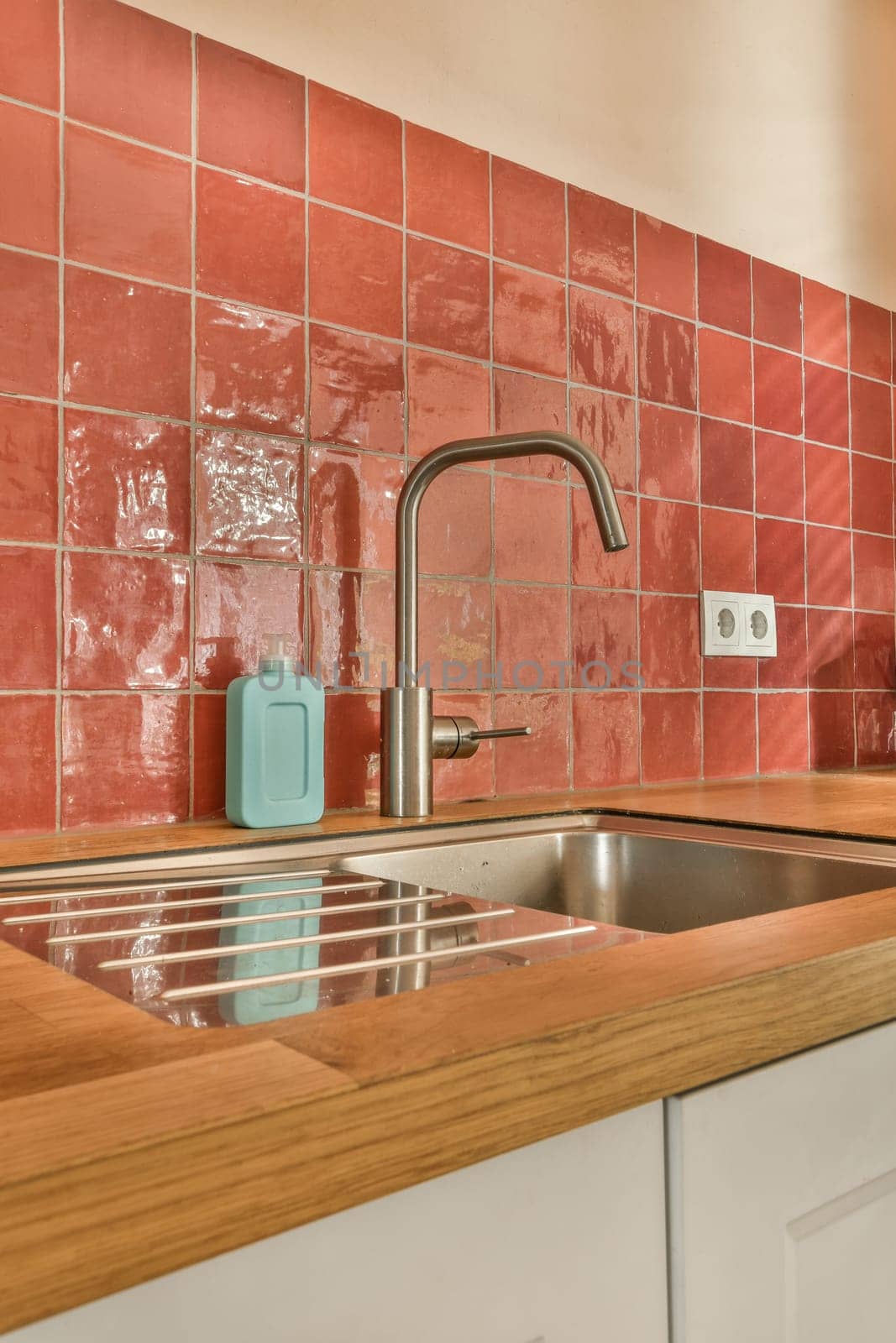 a kitchen with a sink and a faucet by casamedia