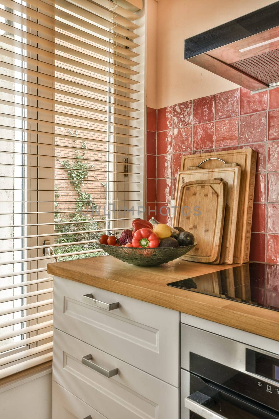 a kitchen with a bowl of fruit on the counter by casamedia