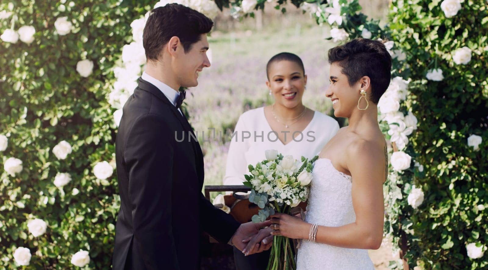 I want to be happy with you. an affectionate young couple smiling at each other while saying their vows on their wedding day