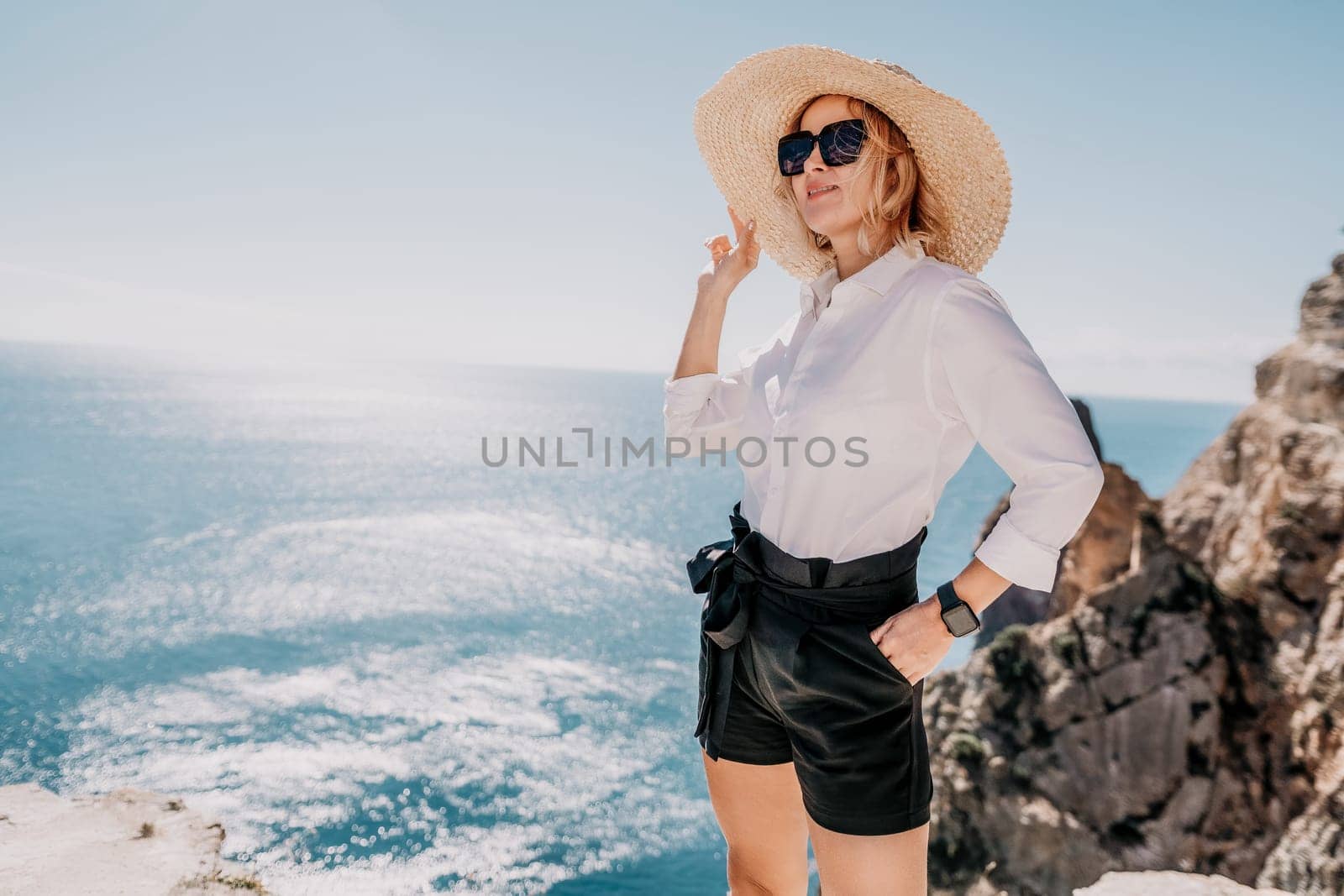 Happy girl doing yoga with laptop working at the beach. beautiful and calm business woman sitting with a laptop in a summer cafe in the lotus position meditating and relaxing. freelance girl remote work beach paradise