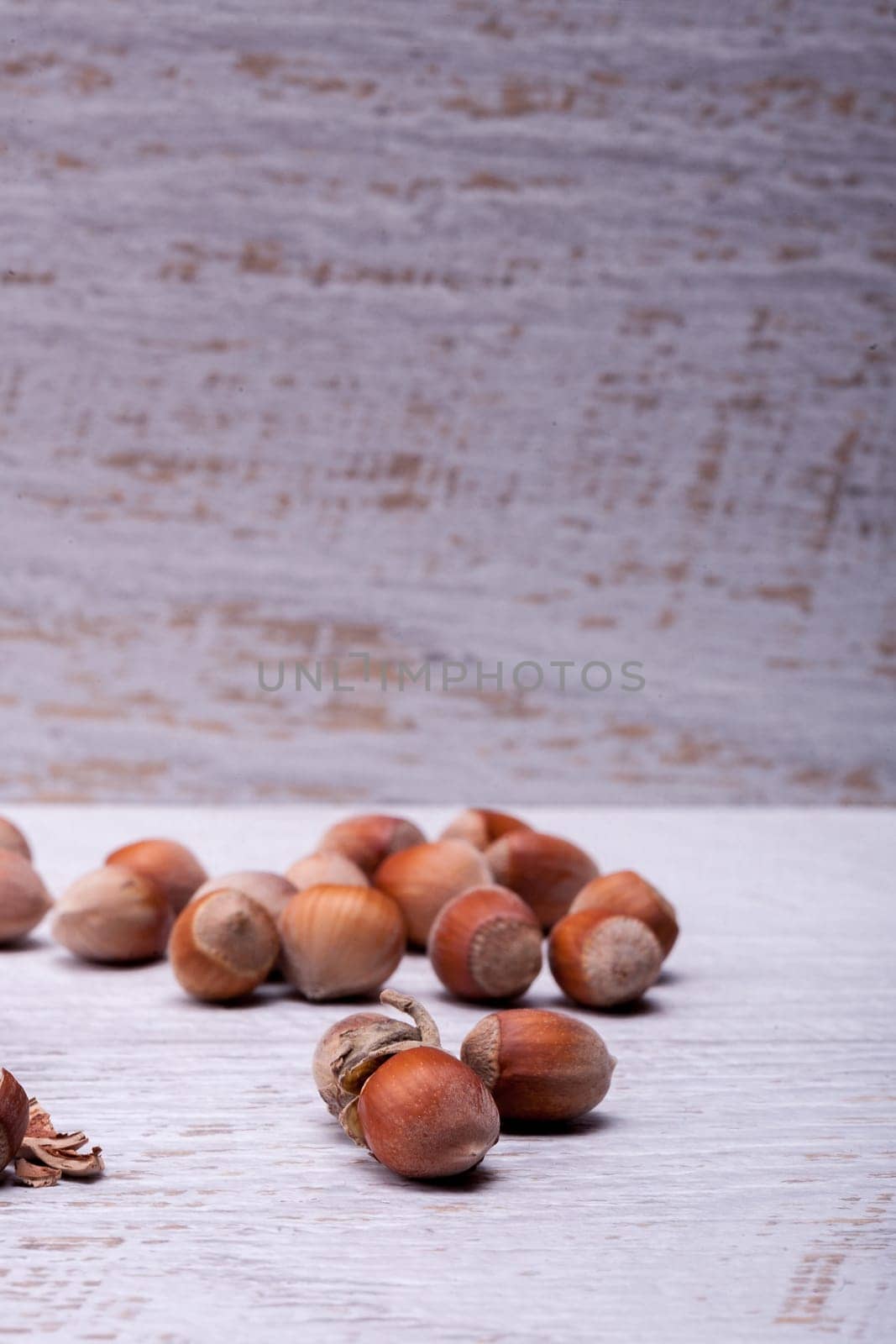 Hazelnuts on white wooden background by DCStudio