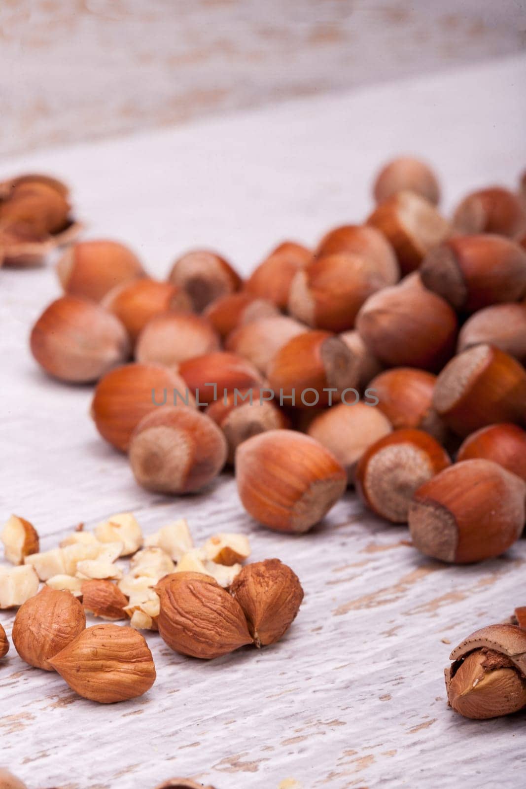Nuts on white wooden background in studio photo by DCStudio