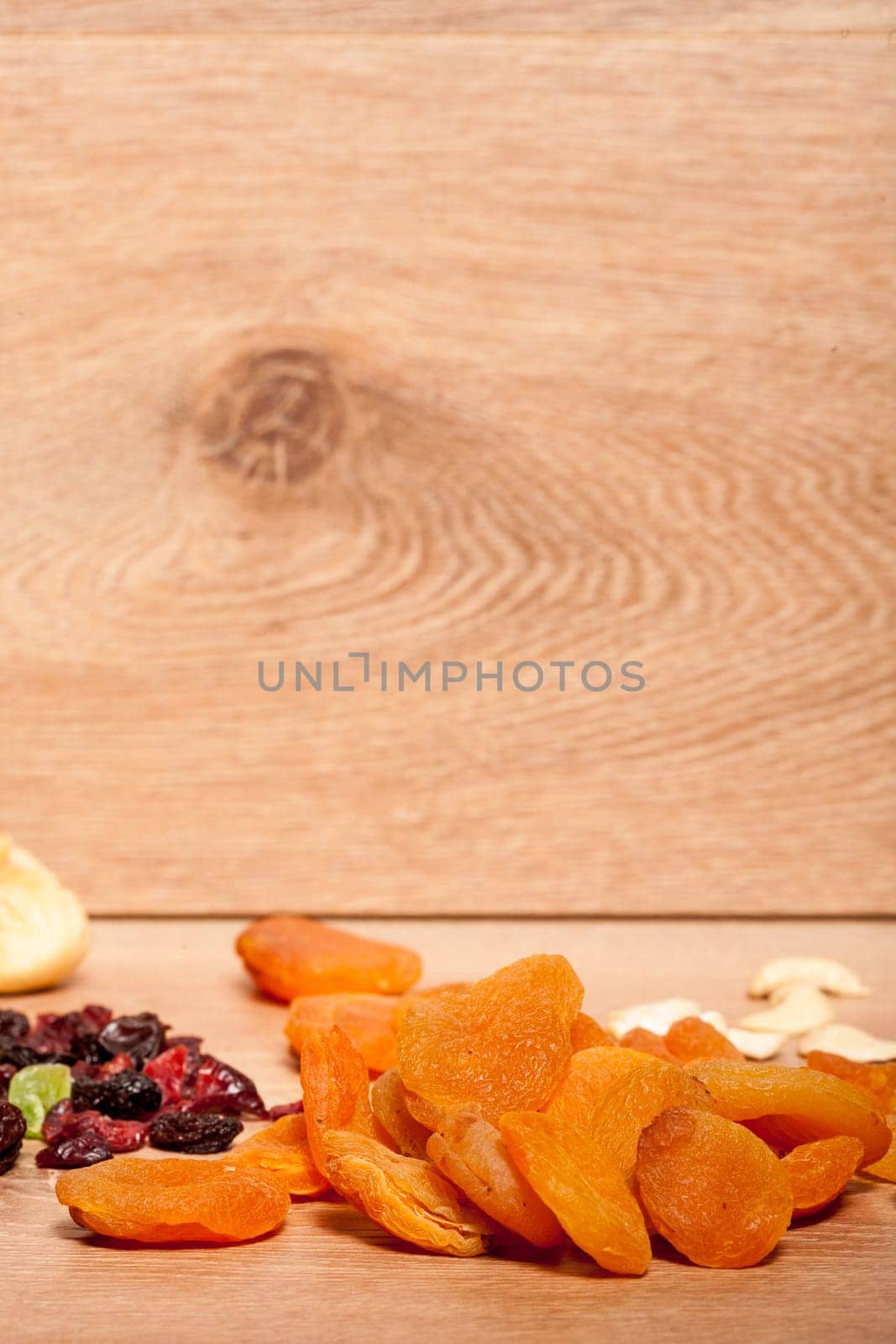 Dried fruits and nuts on wooden background by DCStudio