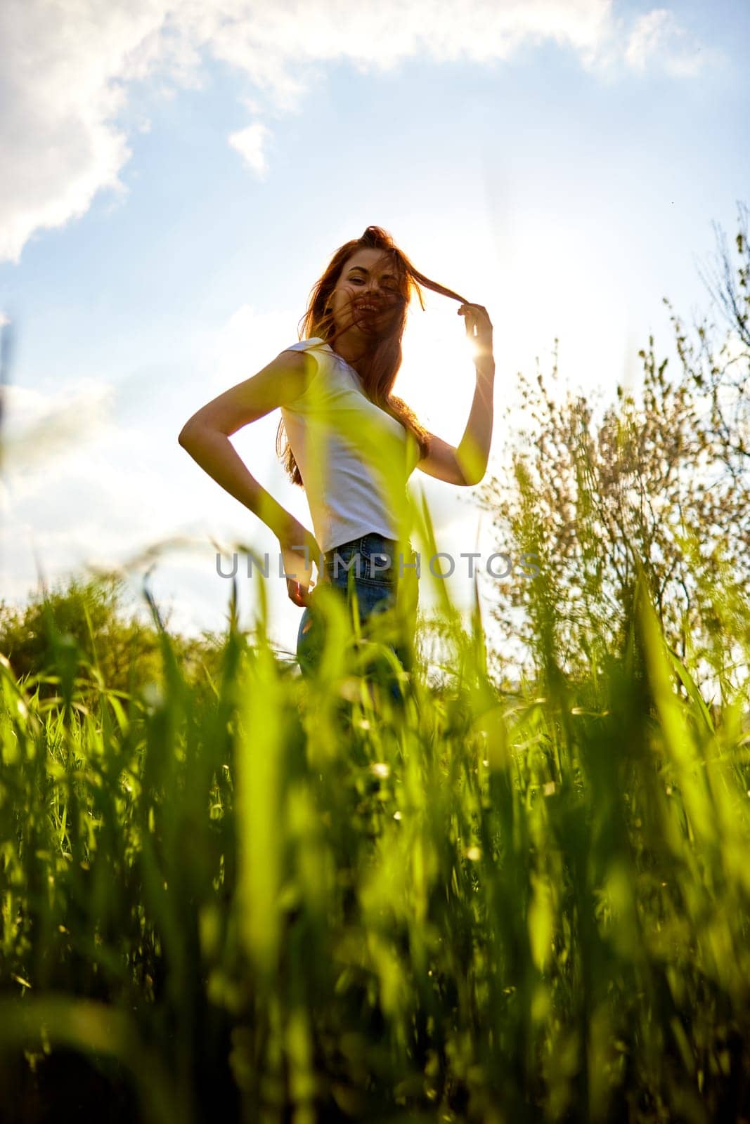 silhouette of a woman standing in a field illuminated from the back. High quality photo