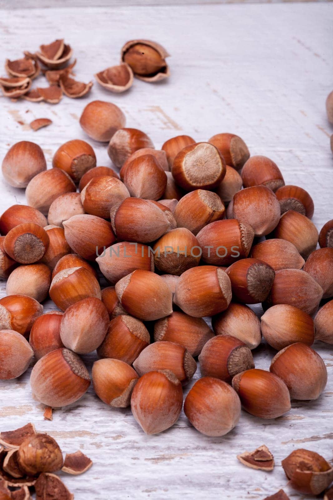 Brown Hazelnuts on white wooden background in studio photo. Healhty snacks