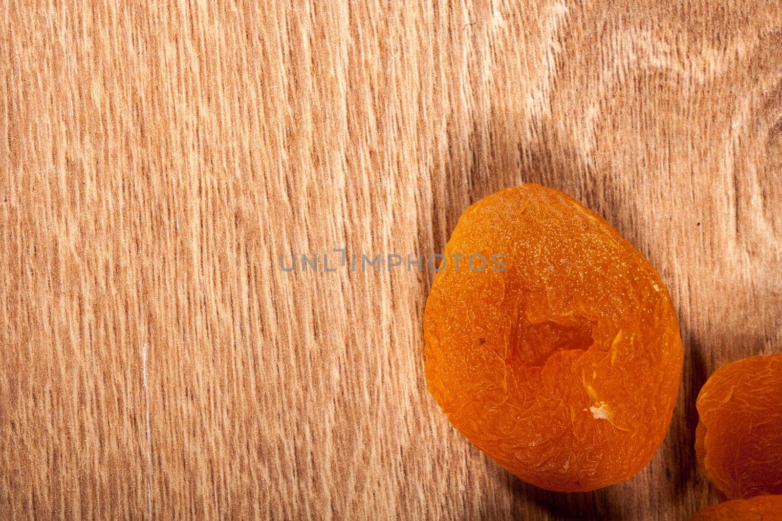 Mix of dried fruits on wooden background by DCStudio