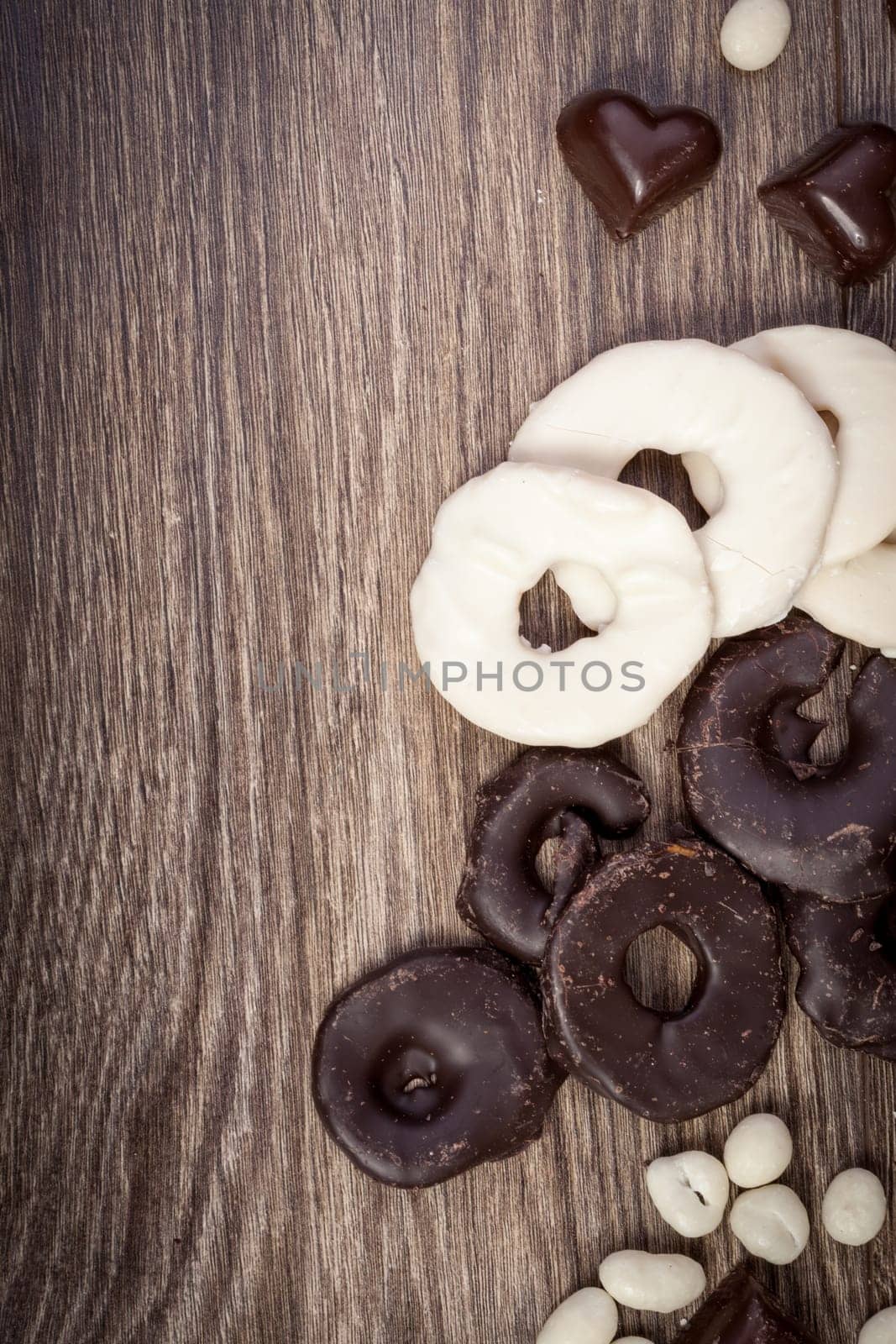 Chocolate and heart shaped desert on wooden background in studio photo with copyright space