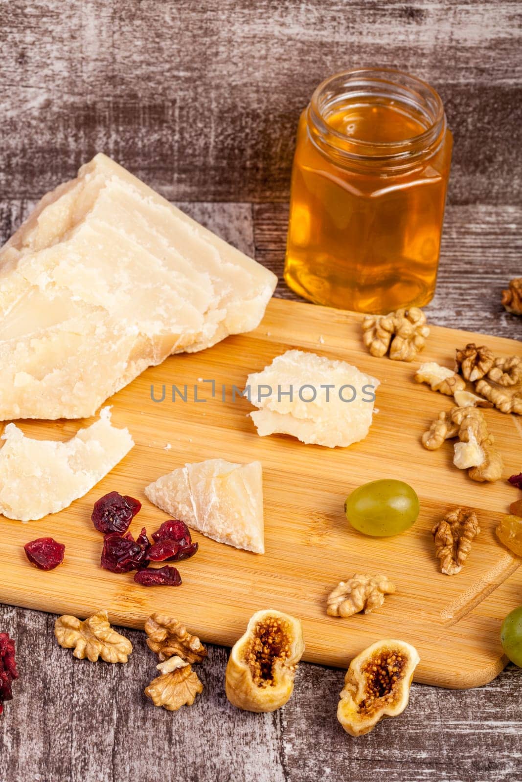 Healthy food. Honey, nuts and cheese on wooden background