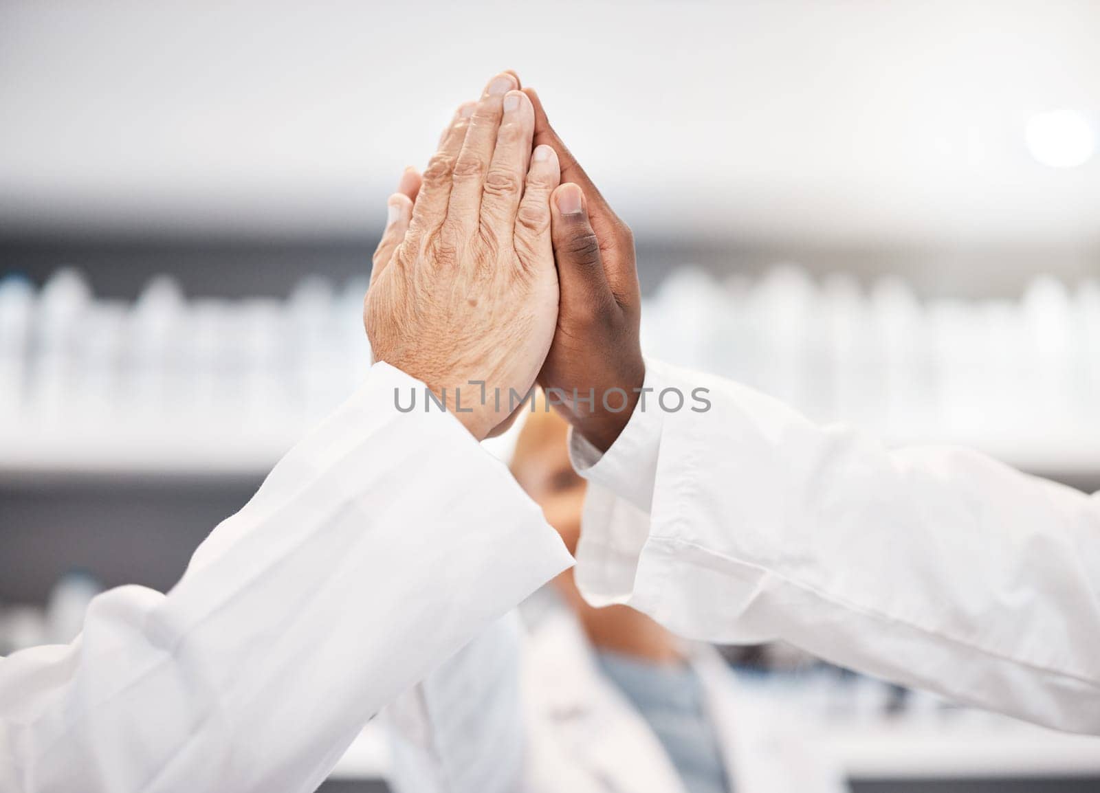 High five hands, scientist and group in lab for results, success or congratulations for pharma. Science teamwork, team building and motivation for research, medical innovation or pharmaceutical study.