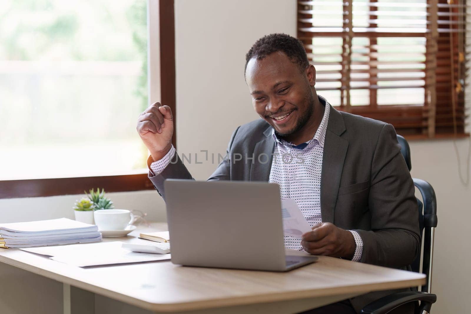 Success American African makes financial report and studies annual figures, analyzes profits. Accountant checks status of financial.