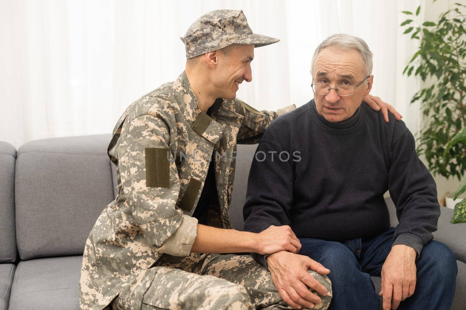 Portrait of army man with parents, elderly father and military son