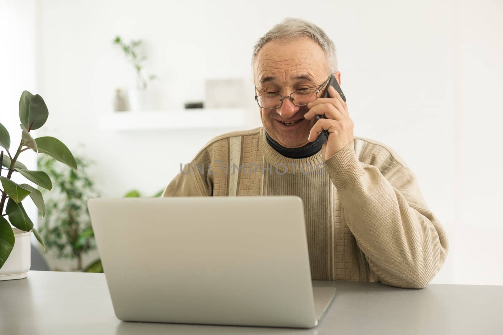 Pensive Senior Man Using Laptop Sitting At Home, Empty Space by Andelov13