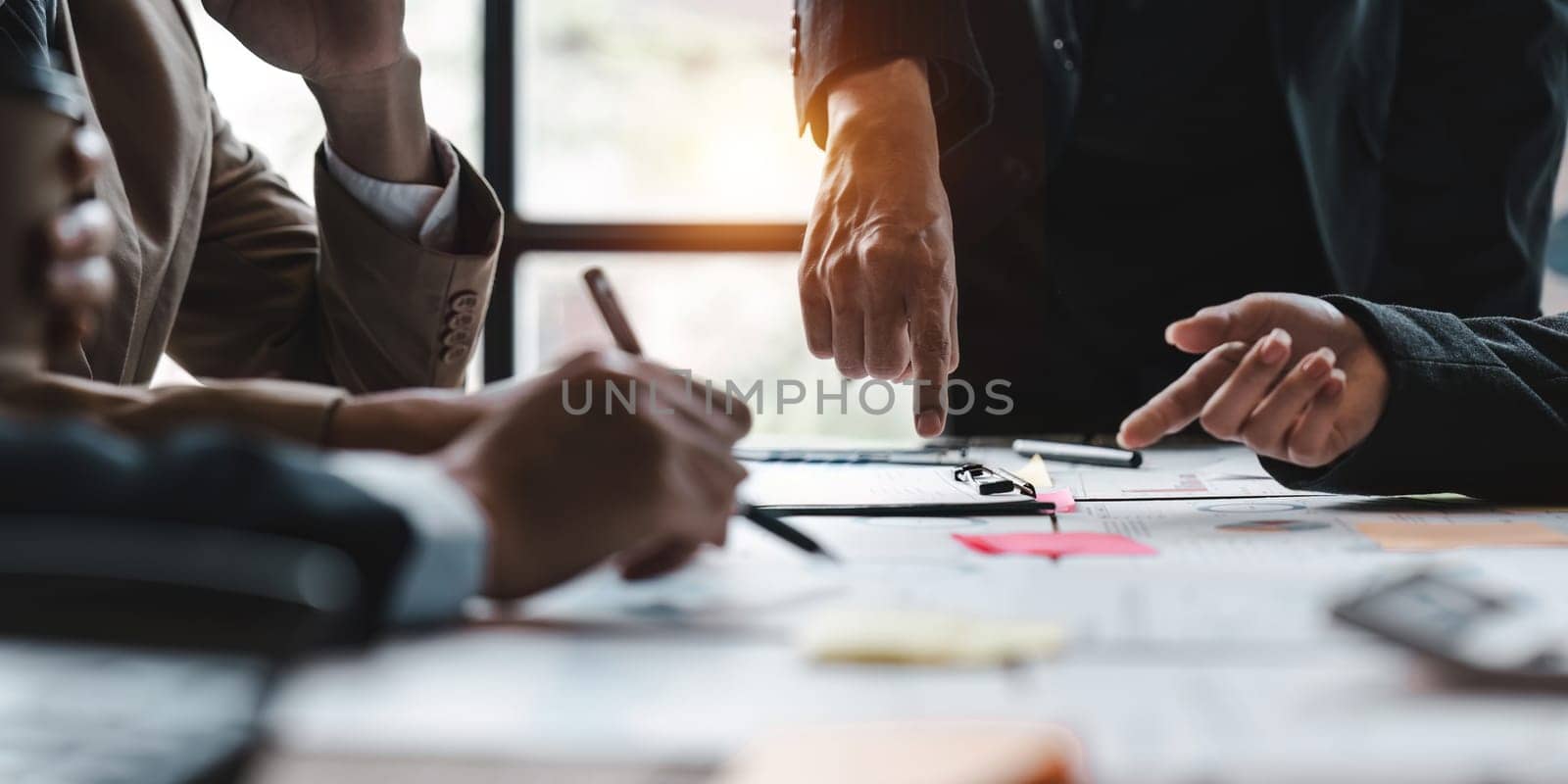 group of business people brainstorm discussing current finance and economy on company investment paperwork at meeting room by nateemee