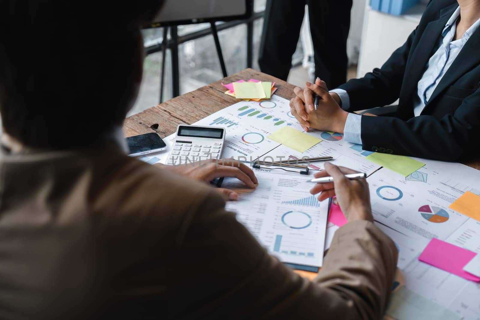 group of business people brainstorm discussing current finance and economy on company investment paperwork at meeting room.