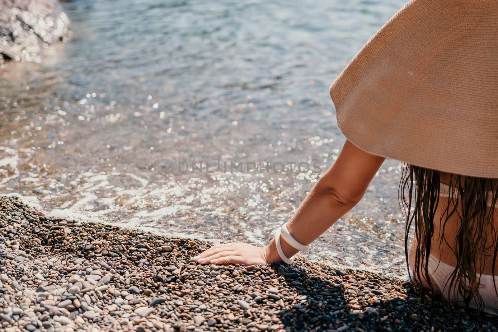 Woman travel sea. Happy tourist taking picture outdoors for memories. Woman traveler looks at the edge of the cliff on the sea bay of mountains, sharing travel adventure journey.