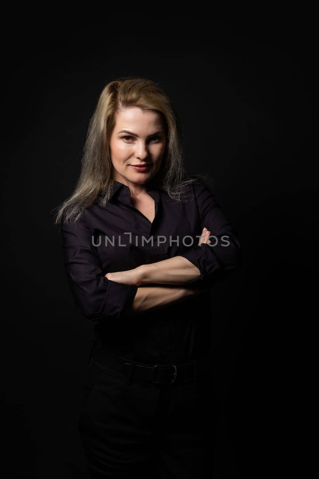 Blonde woman portrait, attractive adult girl in studio over black background