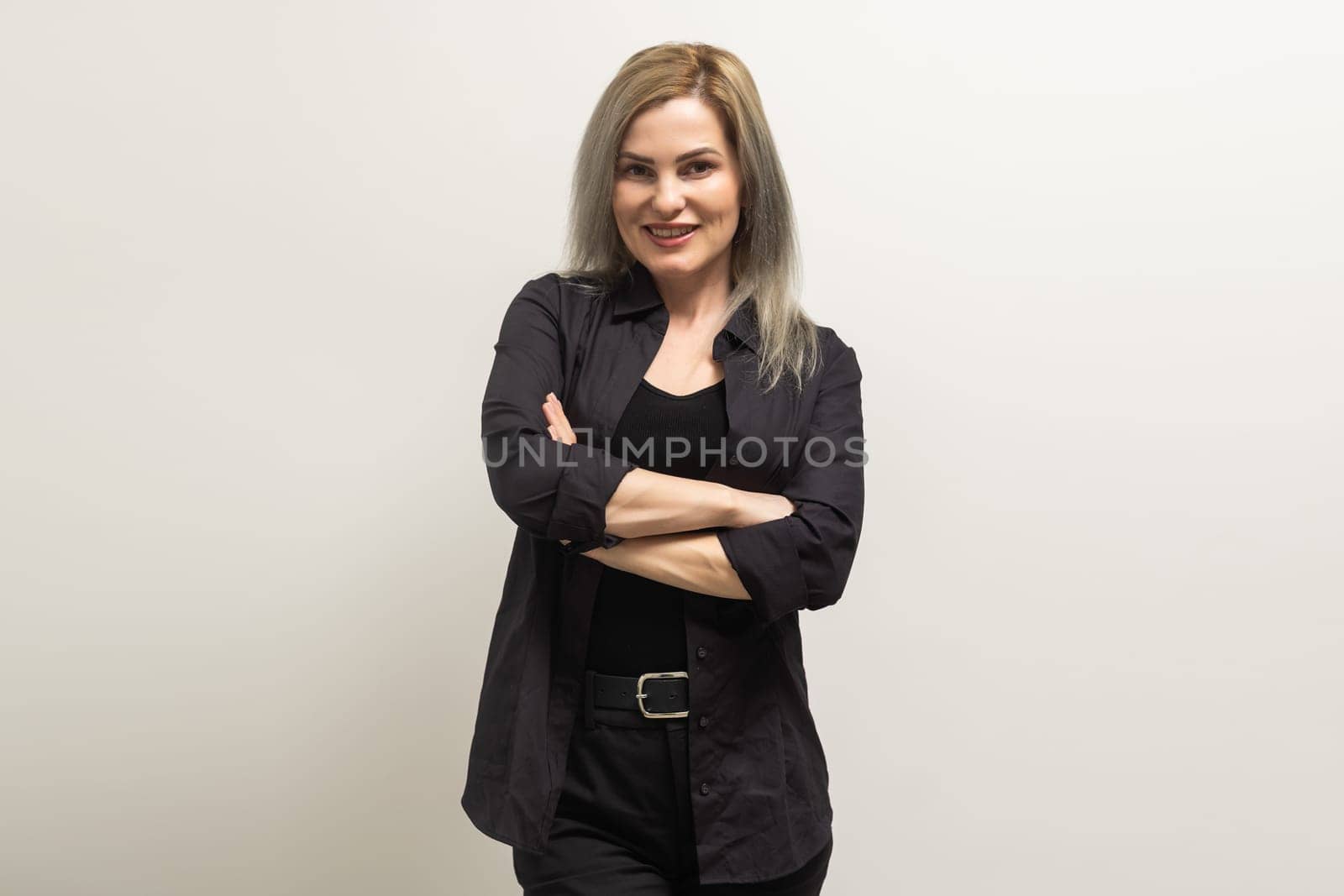 Image of happy young business woman posing isolated over grey wall background