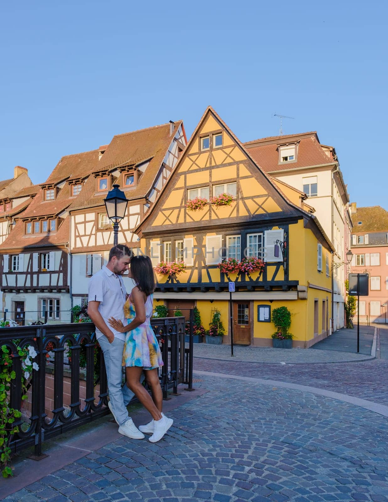 A couple of men and women on vacation at the romantic city Colmar, France, Alsace during summer by fokkebok