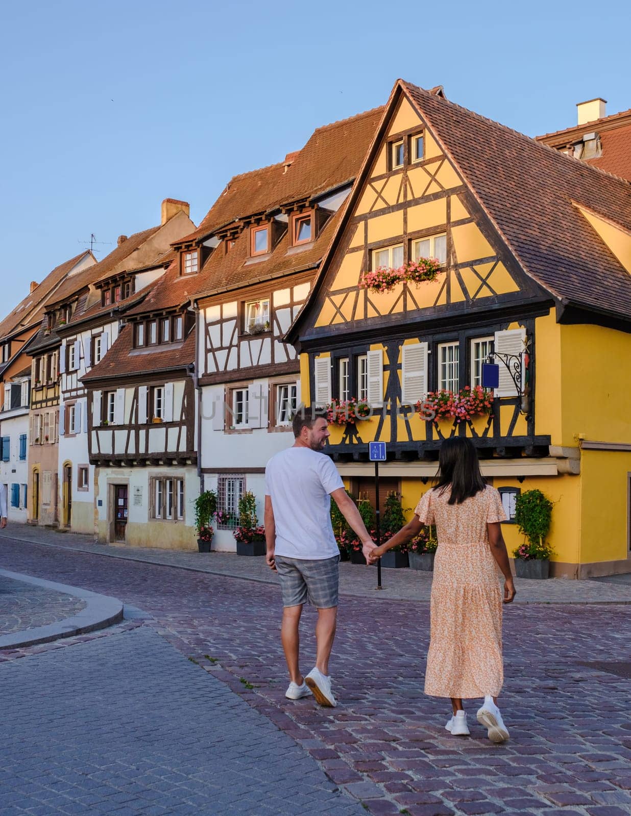 A couple of men and women at the Beautiful colorful romantic city Colmar, France, Alsace by fokkebok