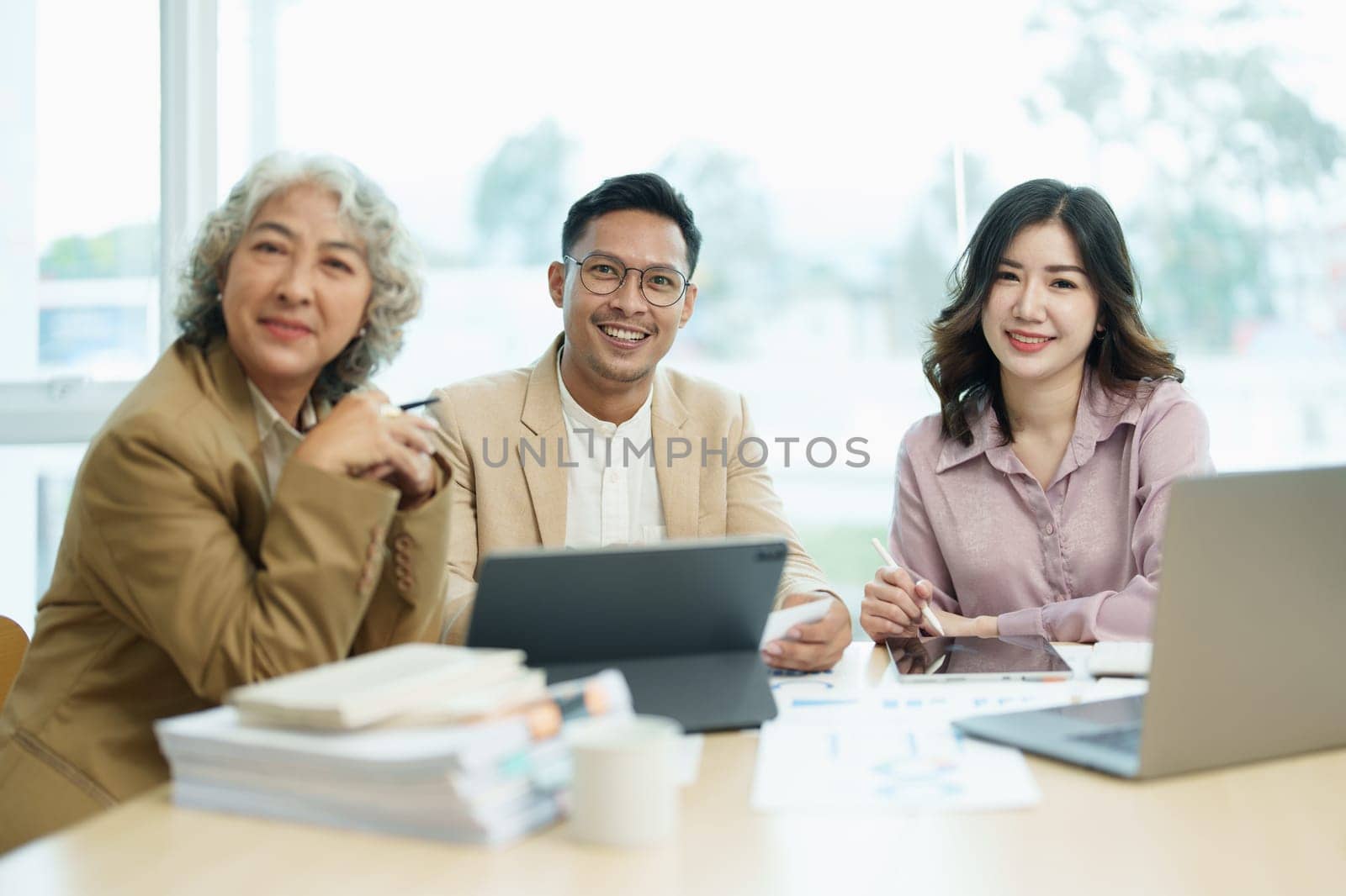 Asian entrepreneurs and business people meeting in a conference room in business planning, financial budget and investment risk assessment to analyze customer groups to increase company growth by Manastrong