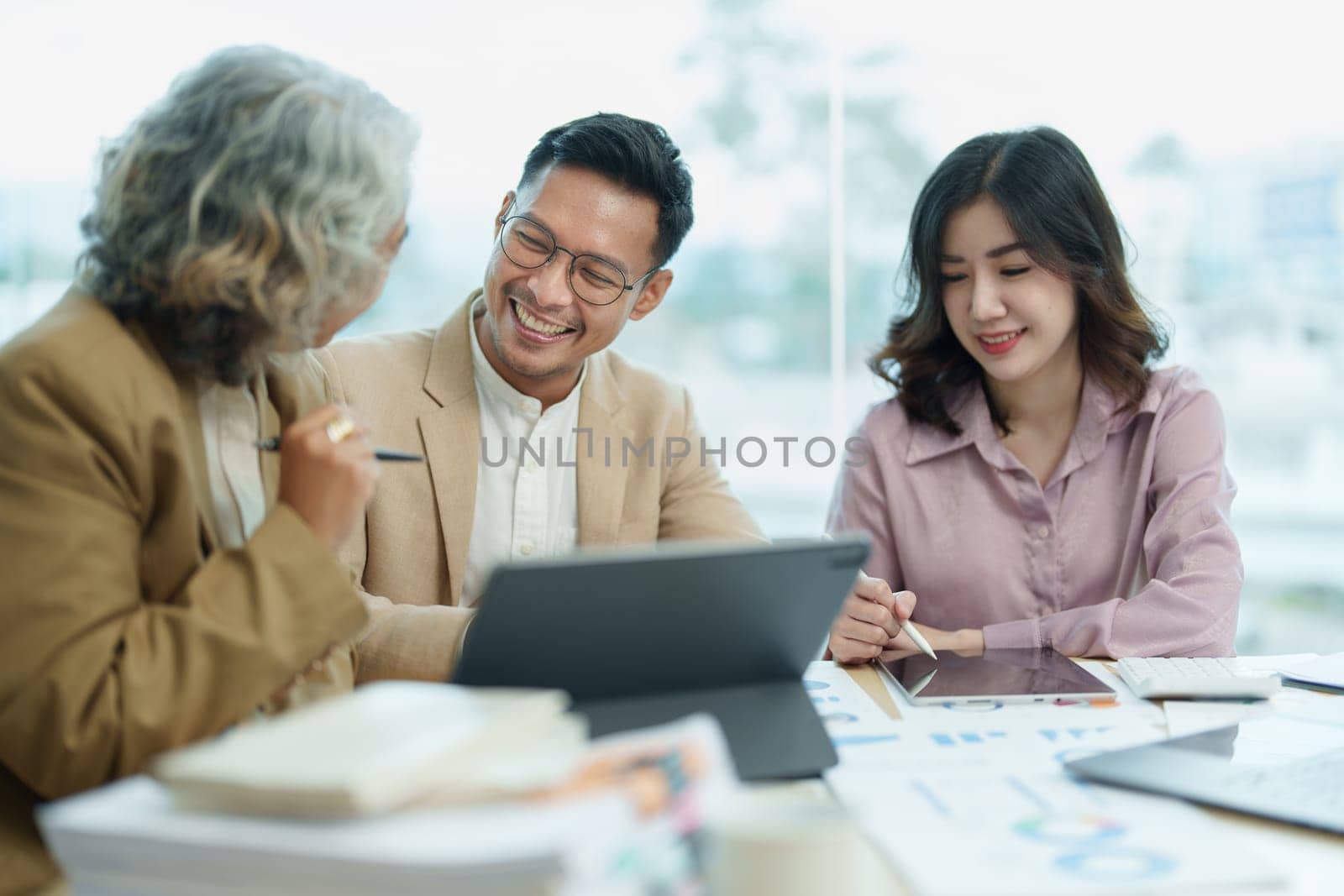 Asian entrepreneurs and business people meeting in a conference room in business planning, financial budget and investment risk assessment to analyze customer groups to increase company growth by Manastrong