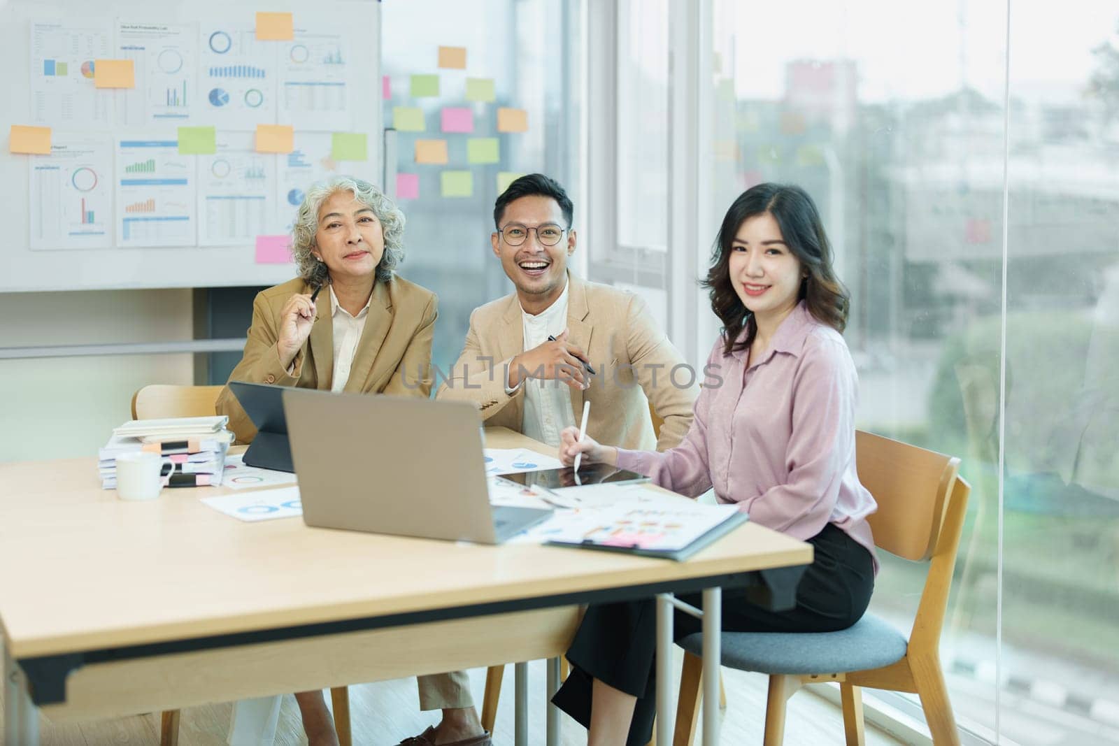 Asian entrepreneurs and business people meeting in a conference room in business planning, financial budget and investment risk assessment to analyze customer groups to increase company growth by Manastrong