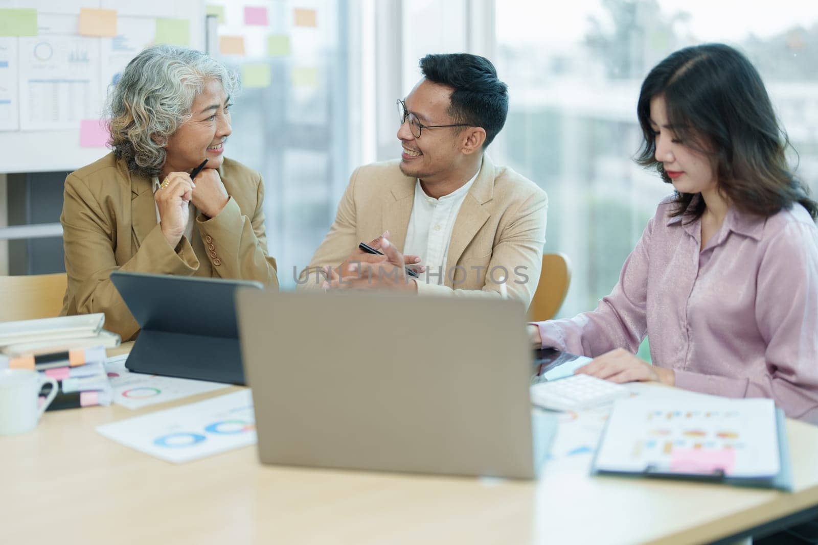 Asian entrepreneurs and business people meeting in a conference room in business planning, financial budget and investment risk assessment to analyze customer groups to increase company growth by Manastrong