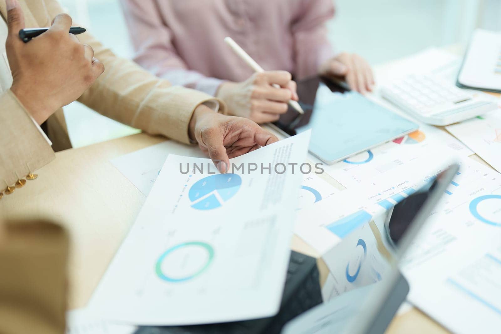 Asian entrepreneurs and business people meeting in a conference room in business planning, financial budget and investment risk assessment to analyze customer groups to increase company growth by Manastrong