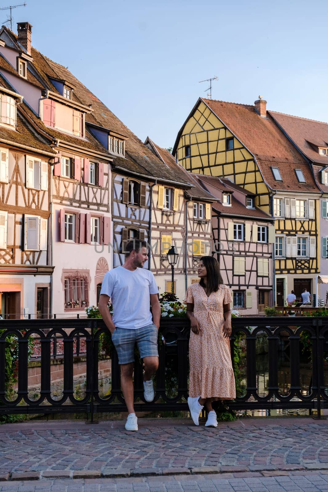 A couple of men and women on vacation at the romantic city Colmar, France, Alsace during summer by fokkebok