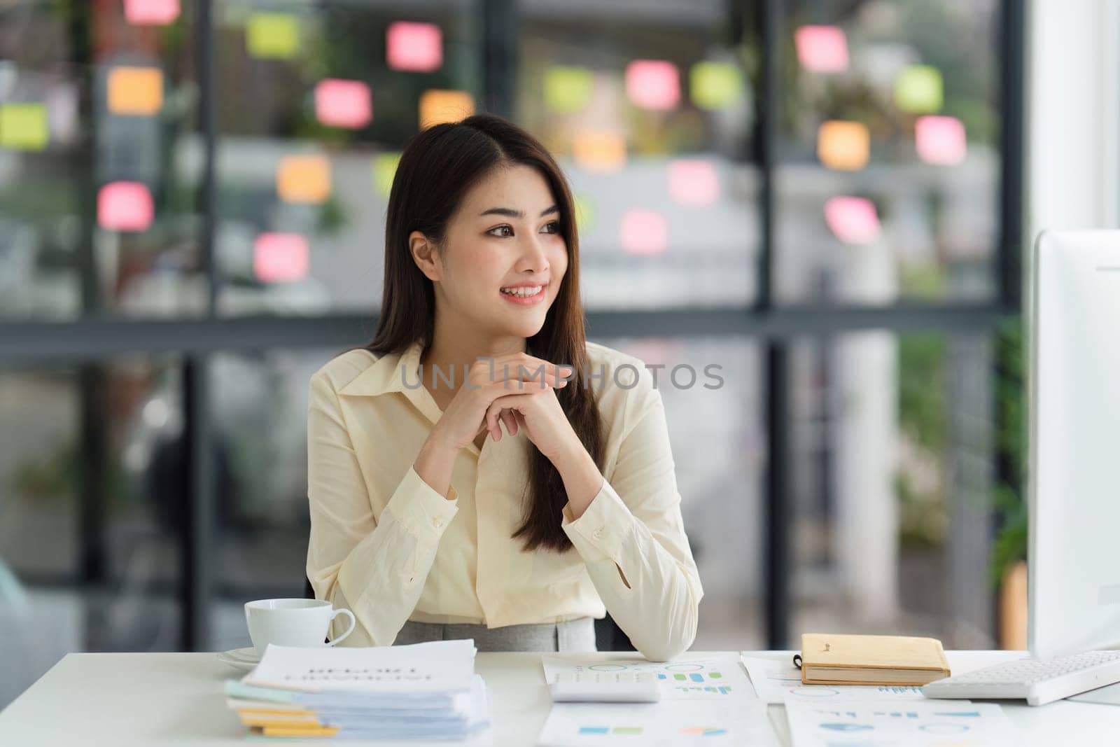 Beautiful Asian Banker or Accountant makes financial report and tax, analyzes profits. Accountant checks status of financial by itchaznong