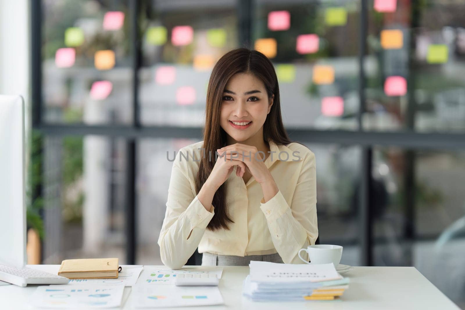 Beautiful Asian Banker or Accountant makes financial report and tax, analyzes profits. Accountant checks status of financial by itchaznong