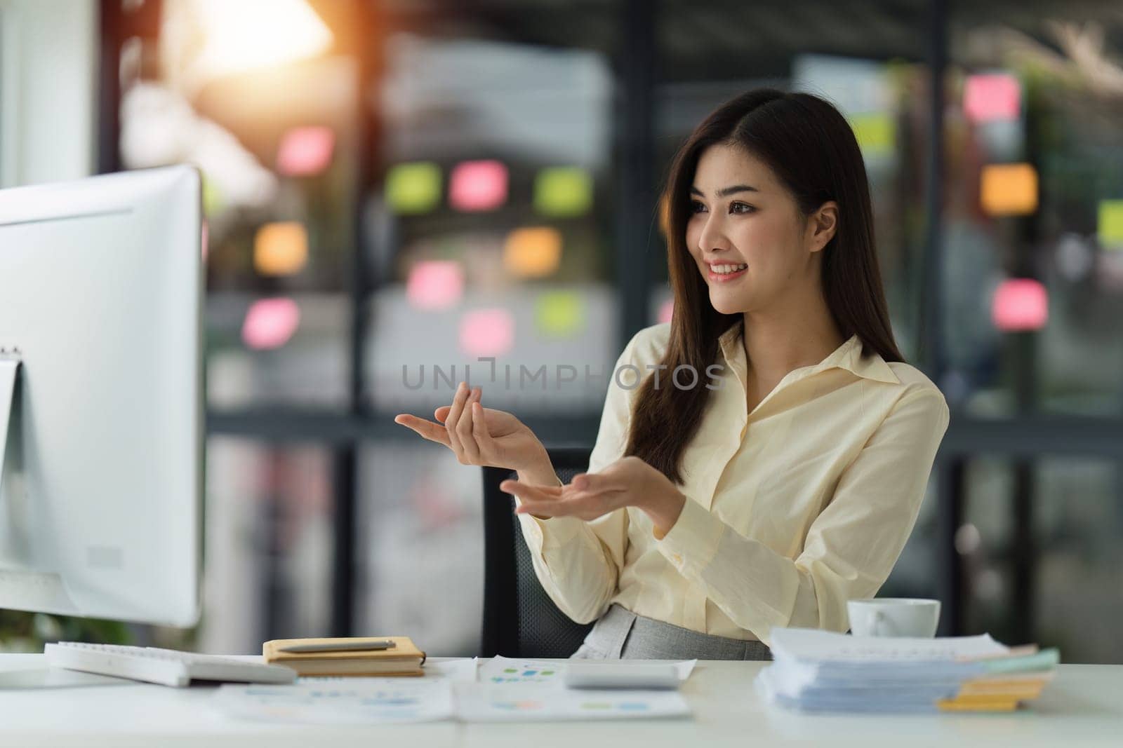 Beautiful Asian Banker or Accountant makes financial report and tax, analyzes profits. Accountant checks status of financial.