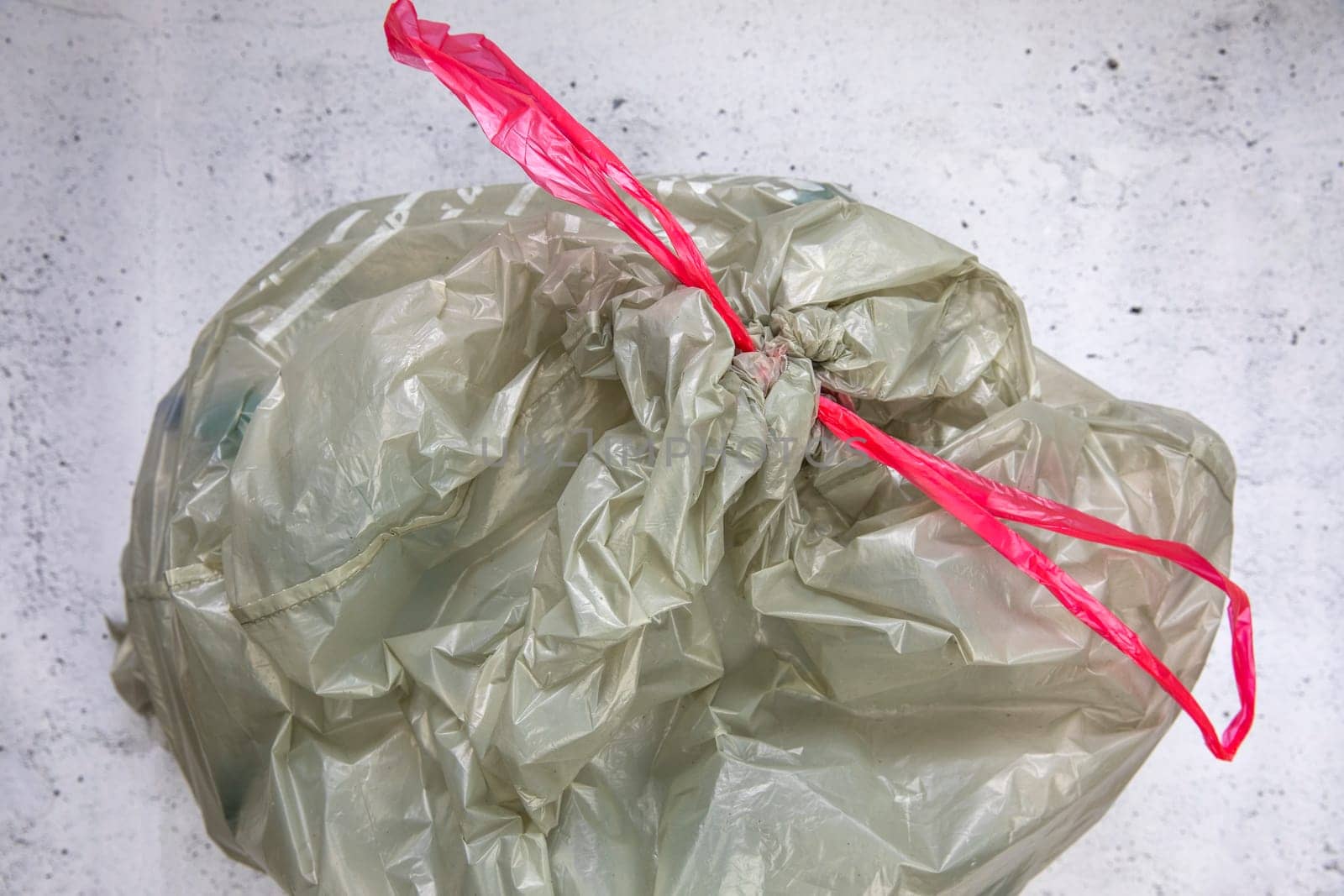 green plastic garbage bag for plastic waste, ready to recycle, waste management top view eco