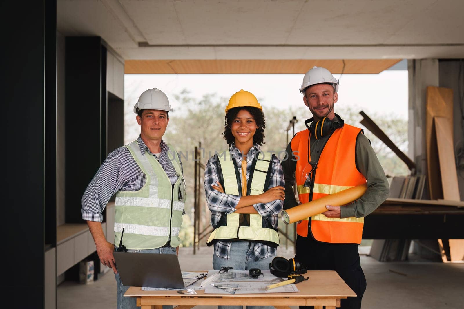 Engineer and Foreman builder team at construction site. American African foreman construction standing at construction site.