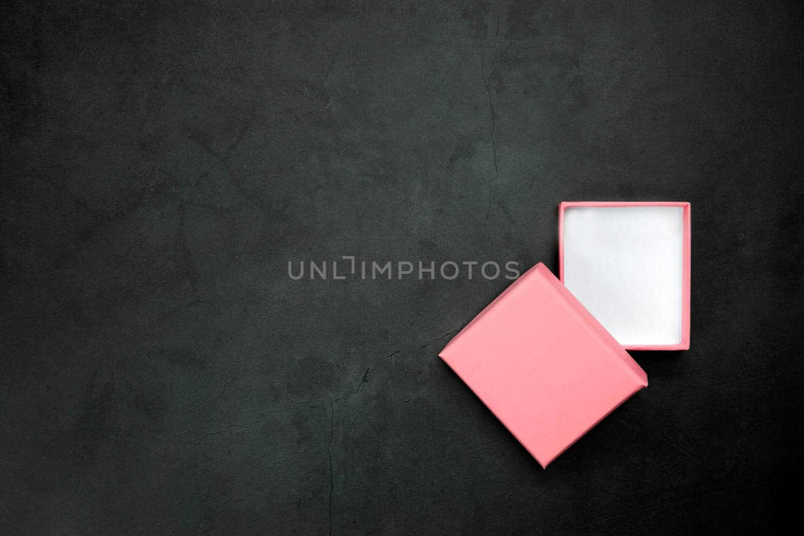 Pink open or closed gift box on a gray concrete background. Top view. Copy space. present,Birthday,Mothers Day,Valentines Day concept by Annebel146