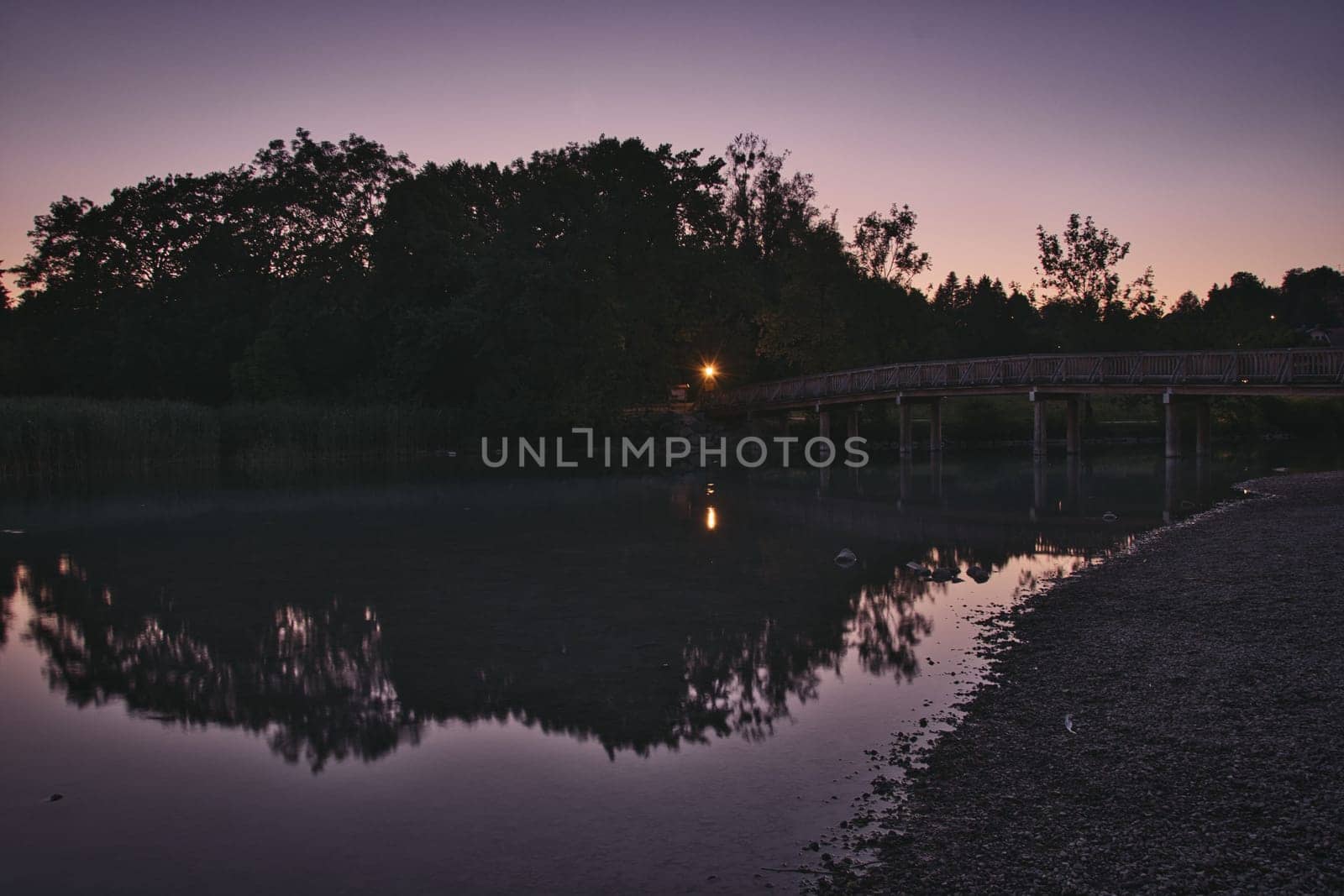 Mangfallsteg bridge with the reflection in river at dusk near Gmund am Tegernsee, Bavaria, Germany