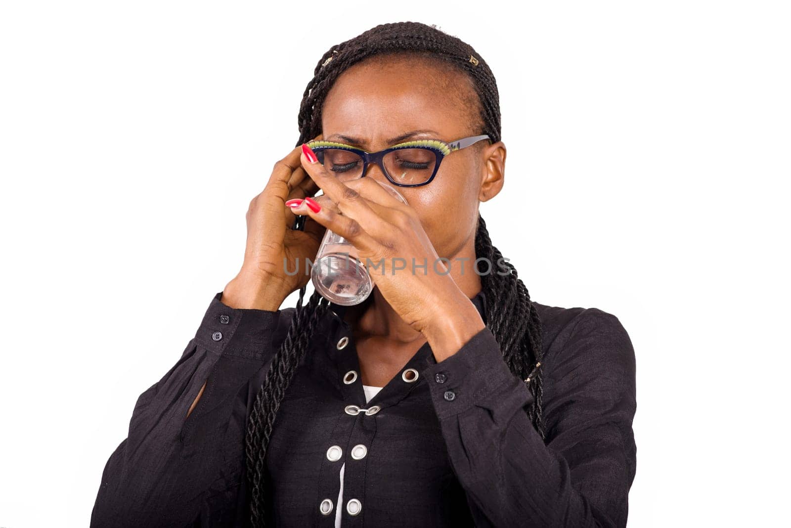 young woman standing in glasses drinking water glass.