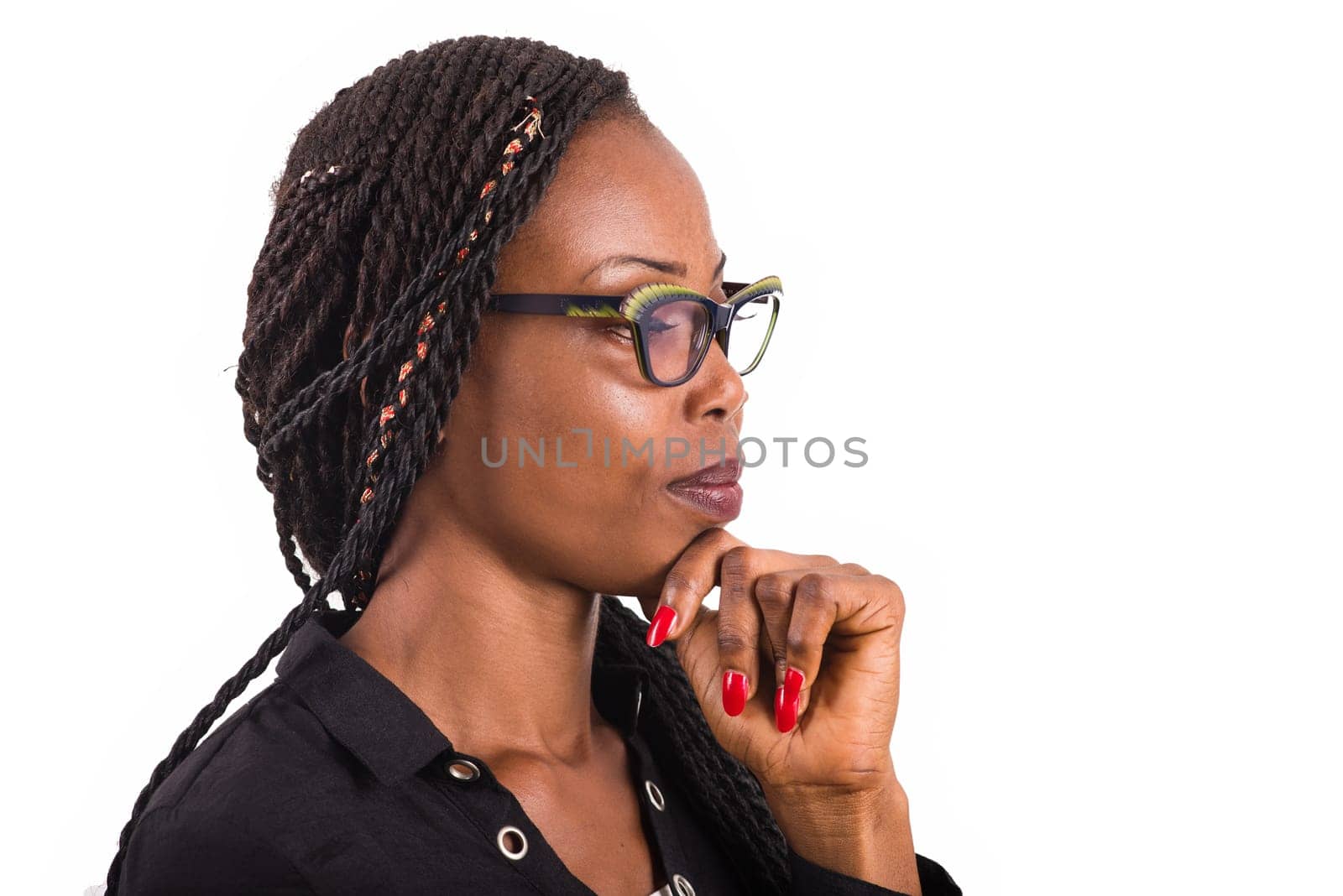 young african woman standing on white background looking in profile.
