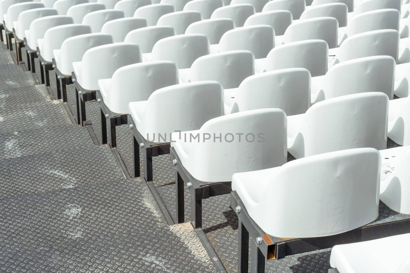 Seats of tribune on sport stadium. Concept of fans, chairs for audience, cultural environment concept. mpty seats, modern stadium. by Matiunina