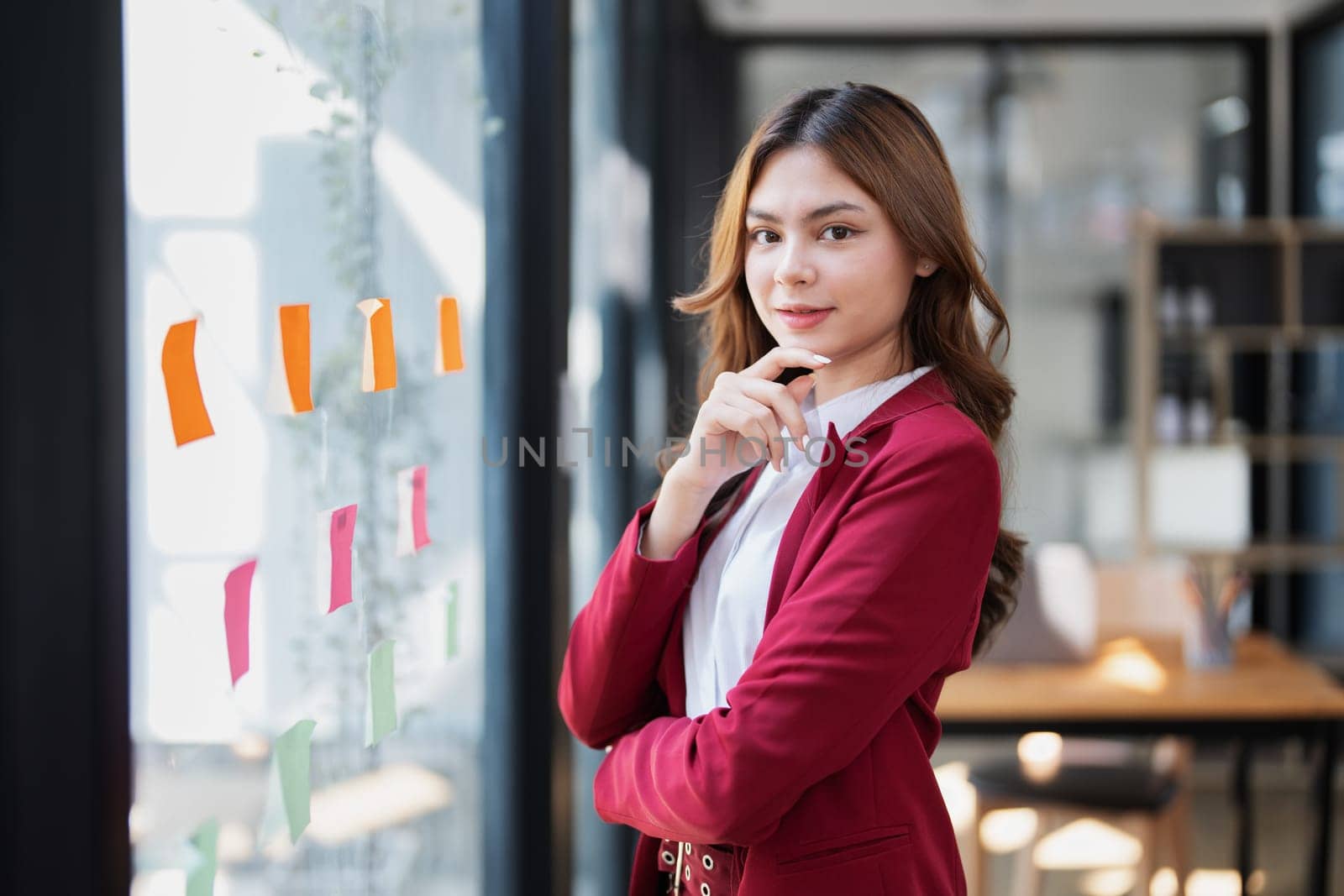 Beautiful young teen asian businesswoman using note pad thinking with planning working on financial document, tax, exchange, accounting and Financial advisor by Manastrong