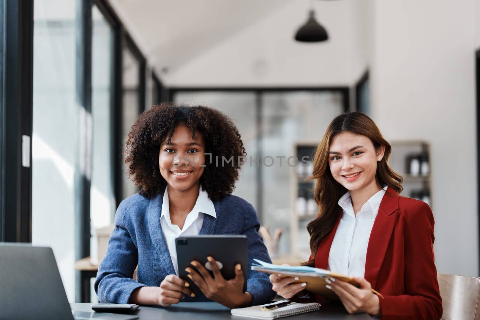 Multiethnic business, Beautiful American African with asian businesswomans people in meeting. Accountant people do document, tax, exchange, accounting and Financial advisor by Manastrong