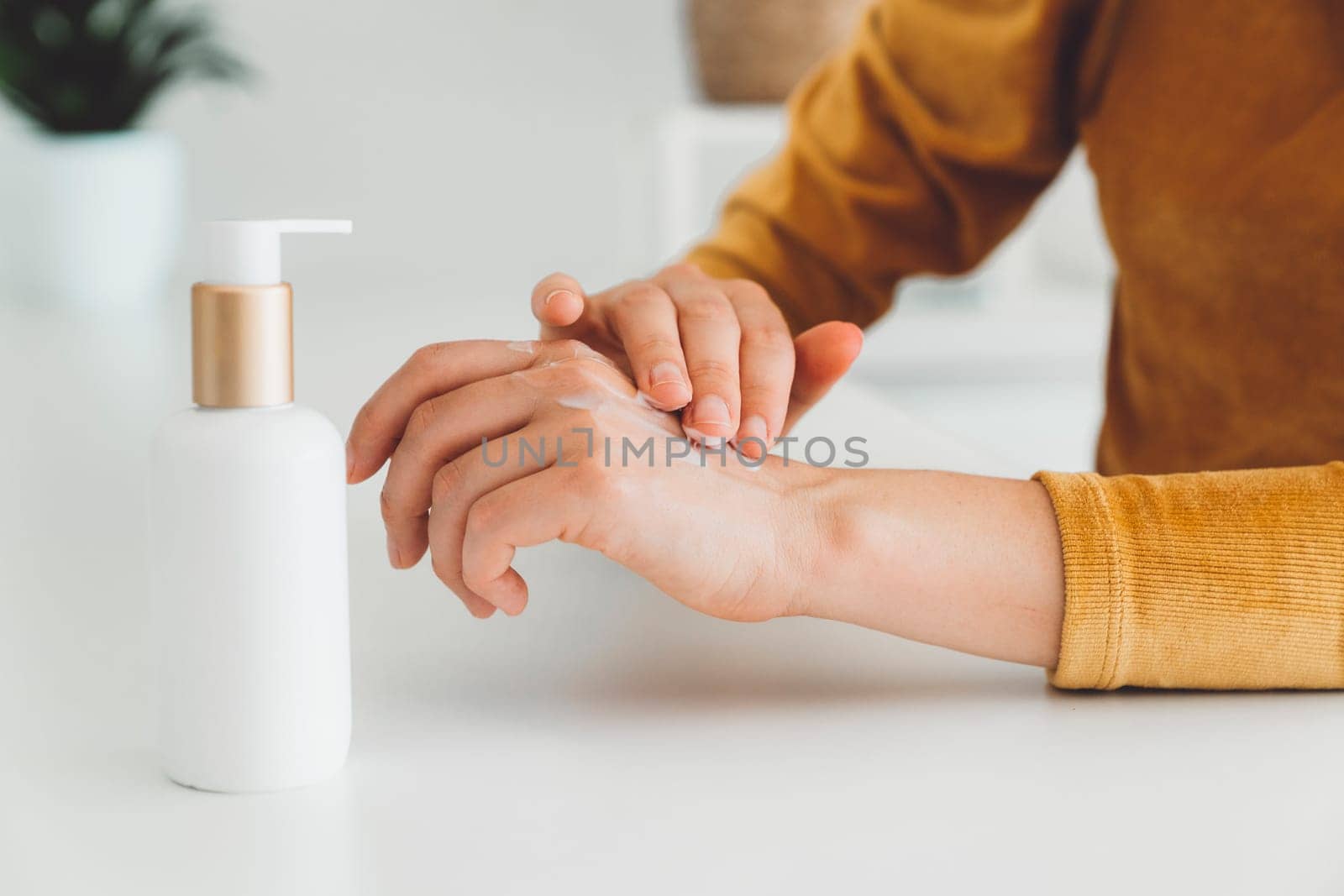 Close up unrecognizable woman hands massaging on hand cream by VisualProductions
