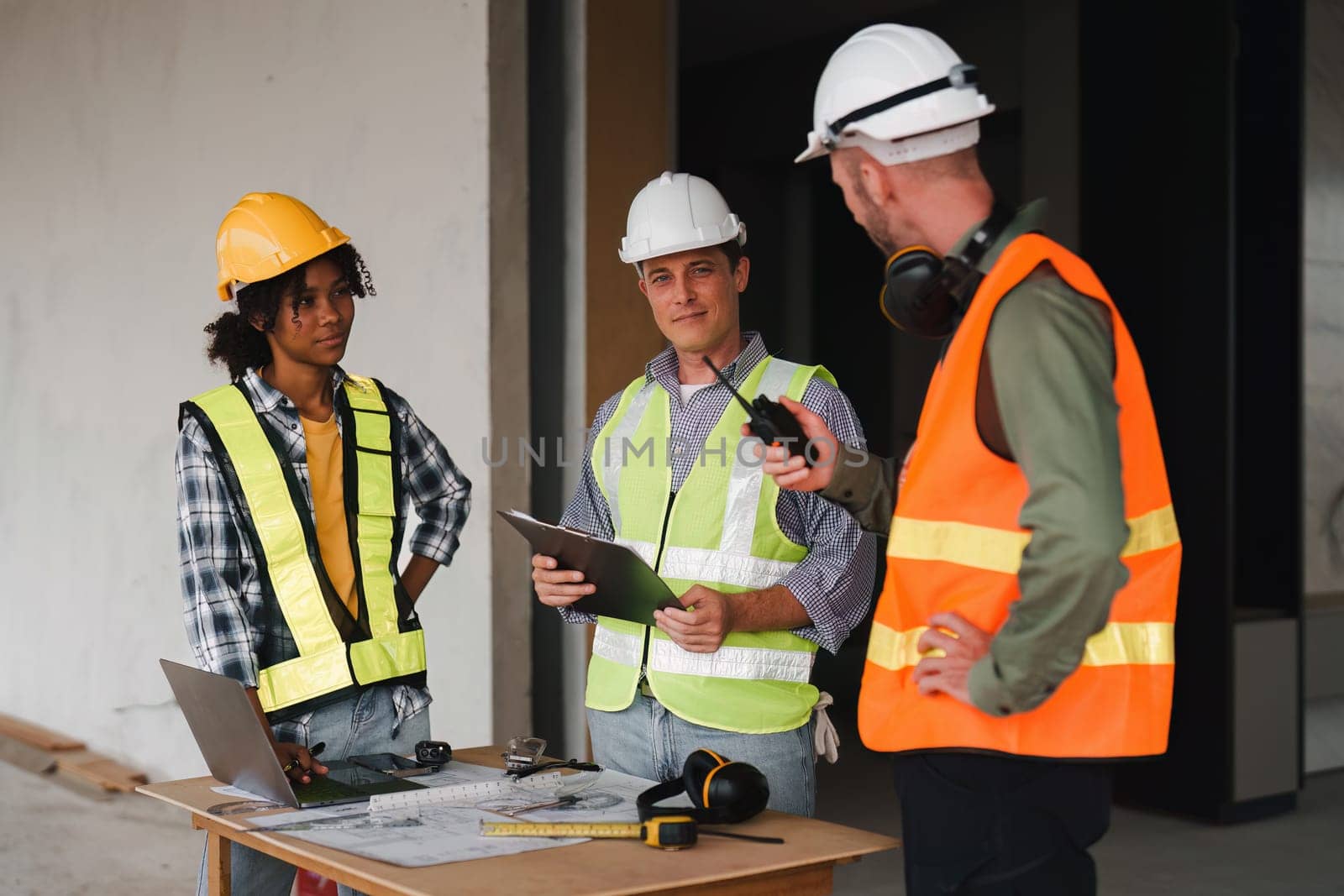 Engineer and Foreman builder team at construction site. American African foreman construction standing at construction site by itchaznong