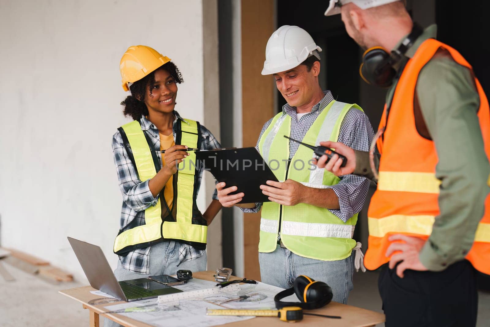 Engineer and Foreman builder team at construction site. American African foreman construction standing at construction site.