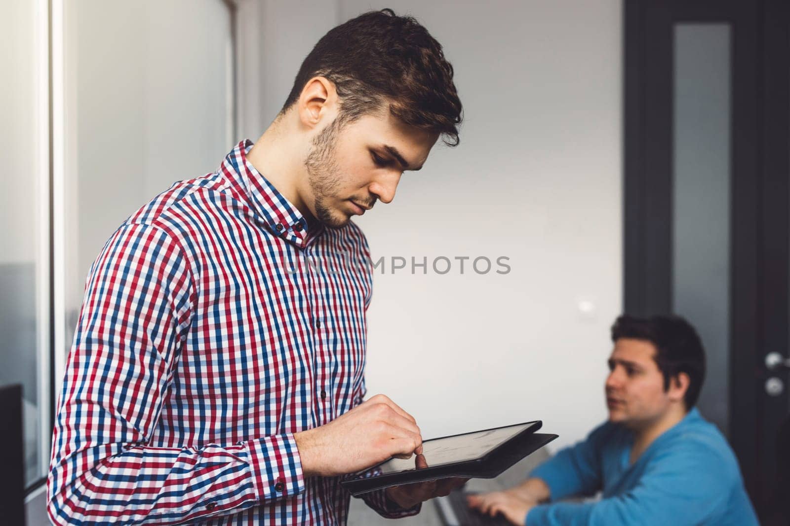 IT Programmer Working on Desktop Computer. Male Specialist Creating Innovative Software Engineer Developing App, Program, Video Game. Terminal with Coding Language. Over Shoulder. High quality photo