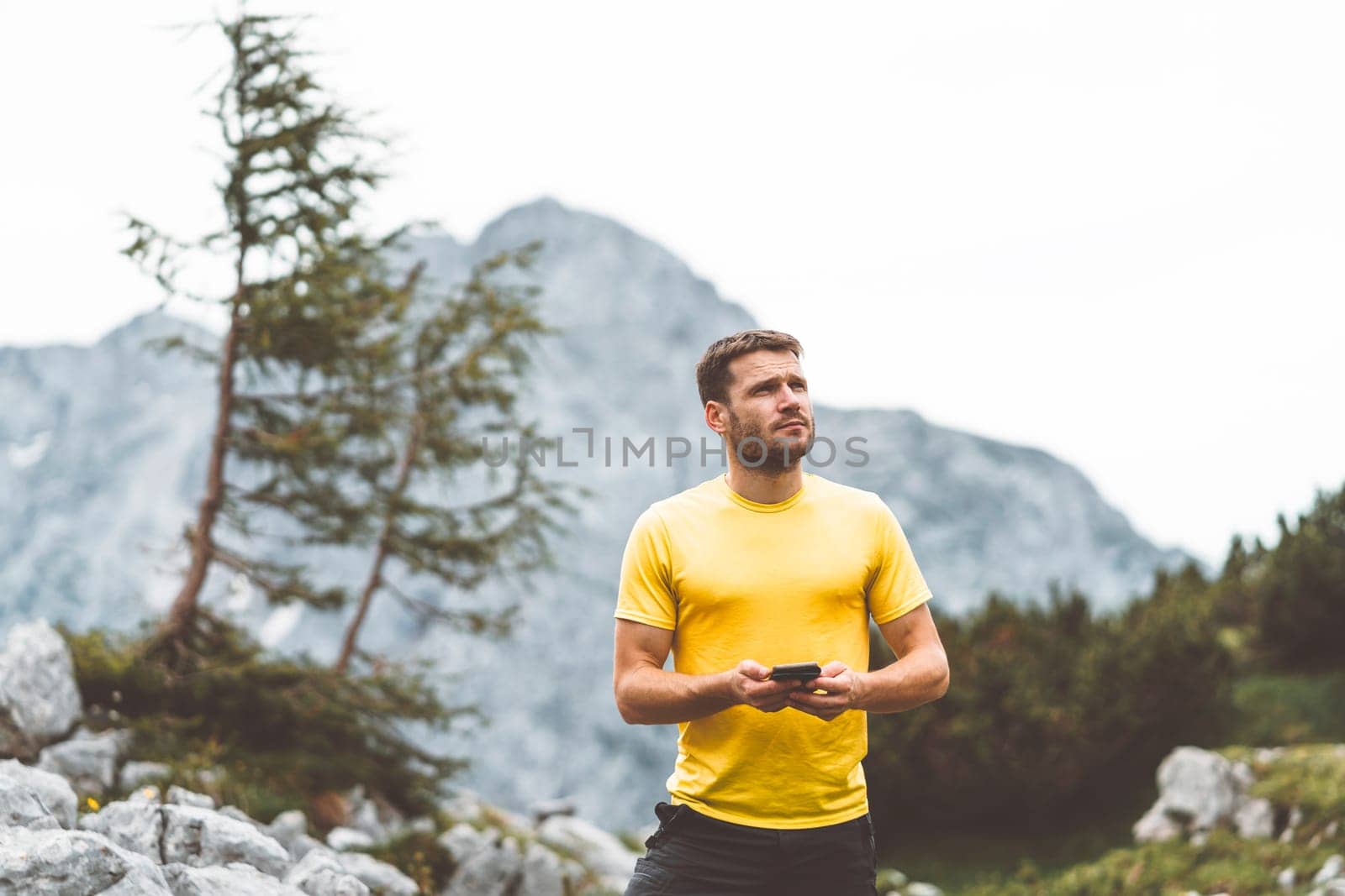 Caucasian man Hiking with Backpack on the Beautiful trail in European Alps early in the morning. Travel and Adventure Concept. High quality photo