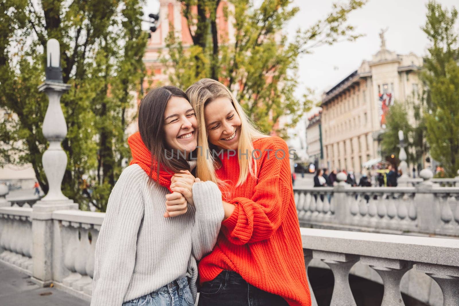 Two young caucasian women having fun on city street outdoors - Best friends enjoying a holiday day out together - Happy lifestyle, youth and young females concept. High quality photo