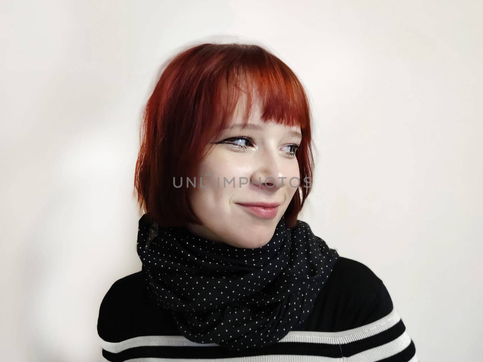 portrait of a smiling red-haired teenage girl in a black scarf on a white background by Annado